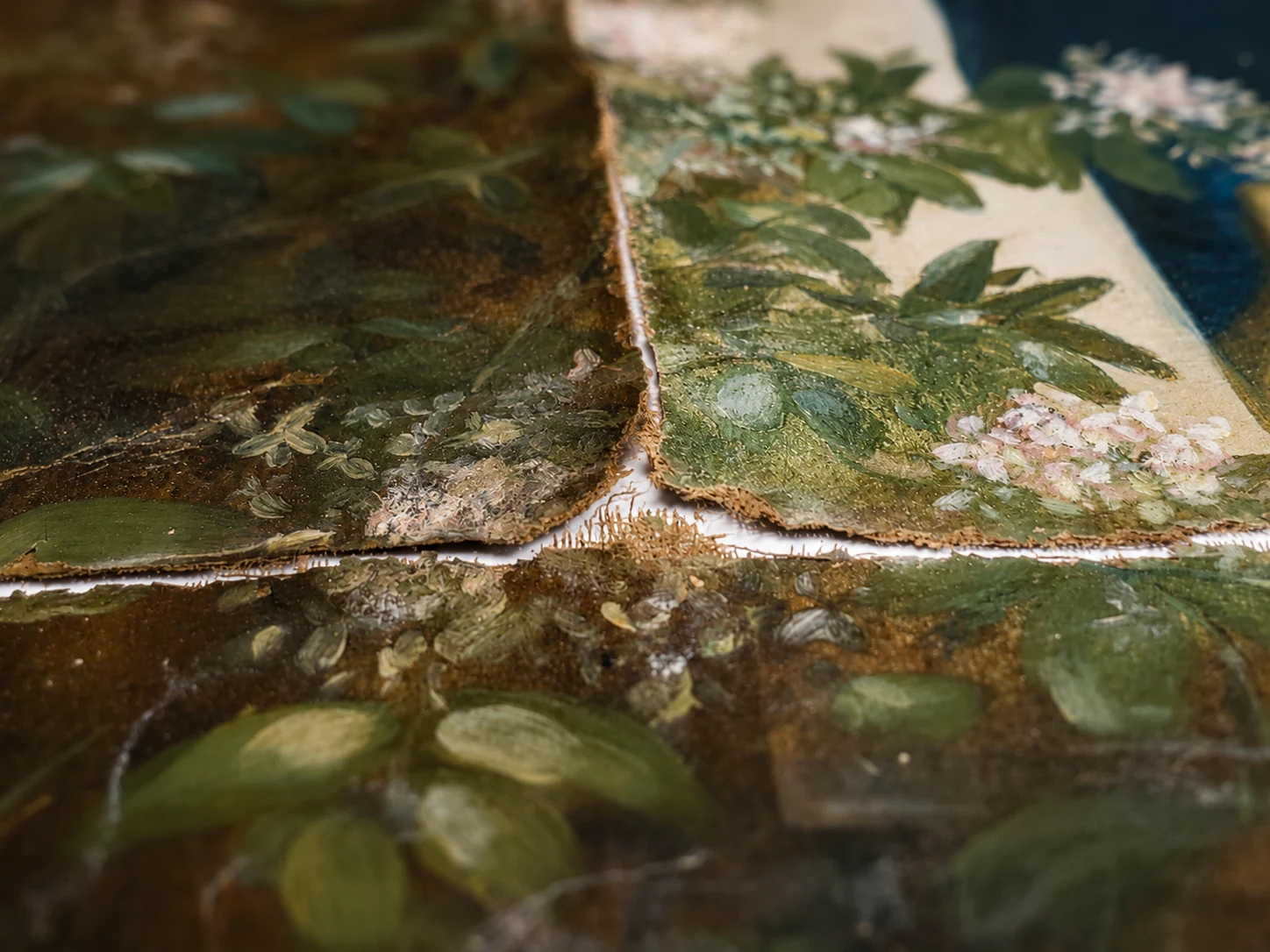 Macro detail of torn painted canvas