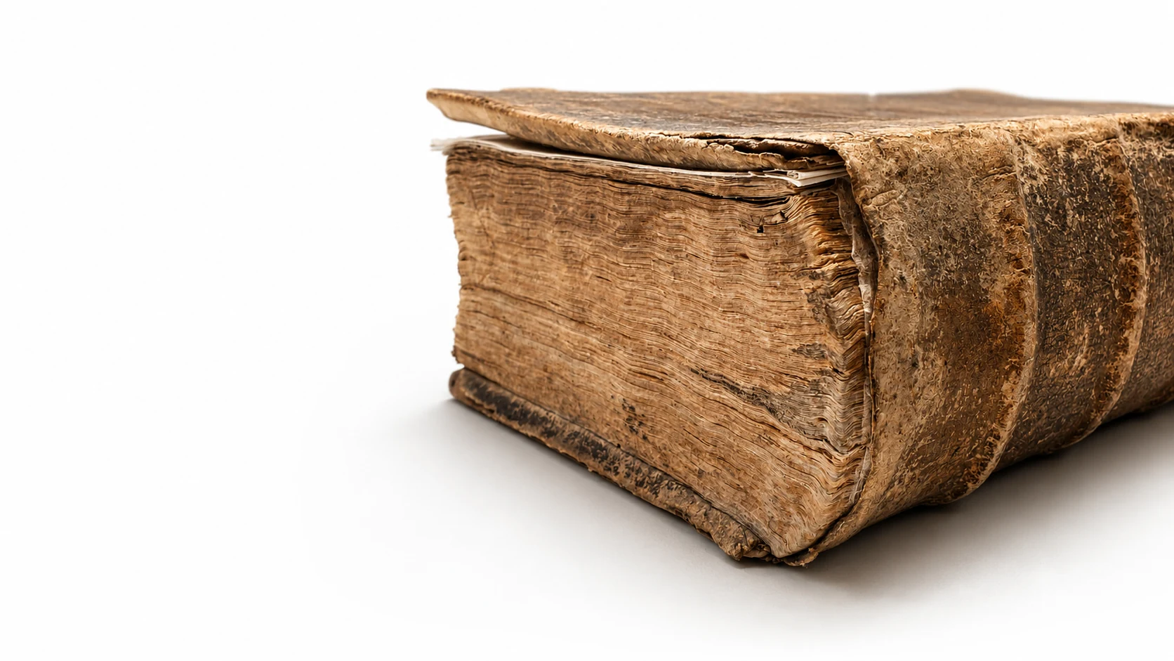 Close view of a centuries-old rare book and its worn page edges