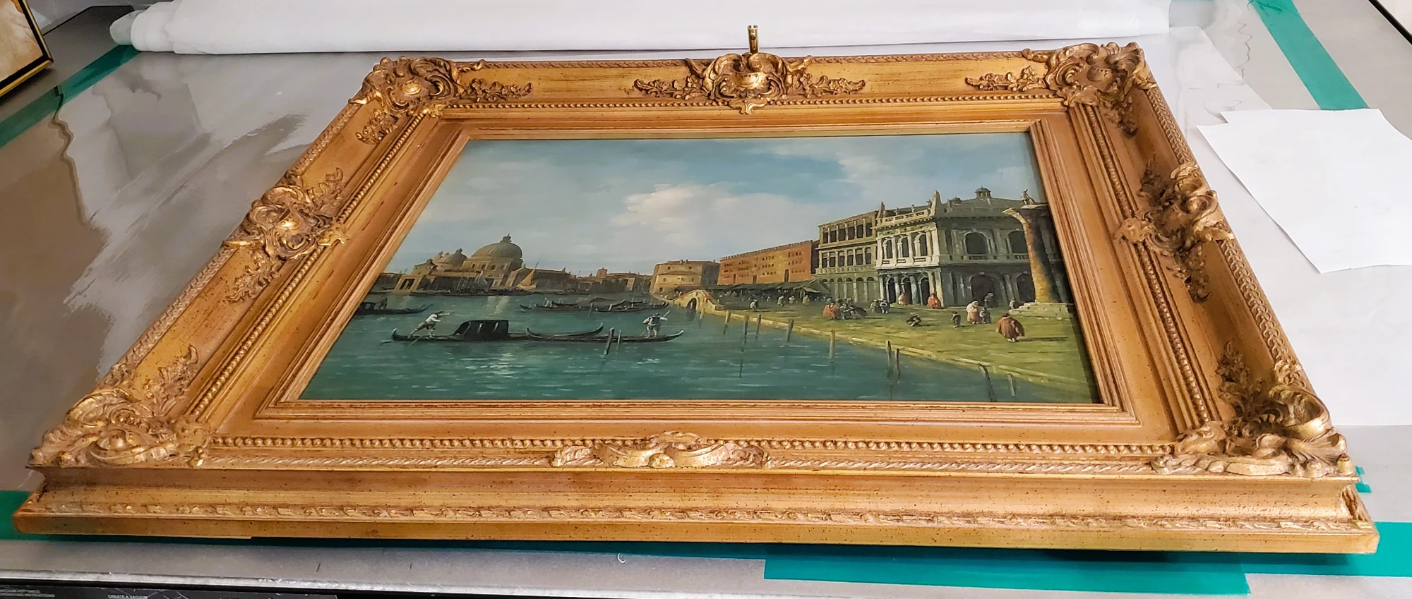 Historic framed Venice painting in the conservation studio
